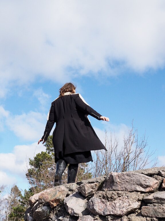 Woman walking trying to keep her balance