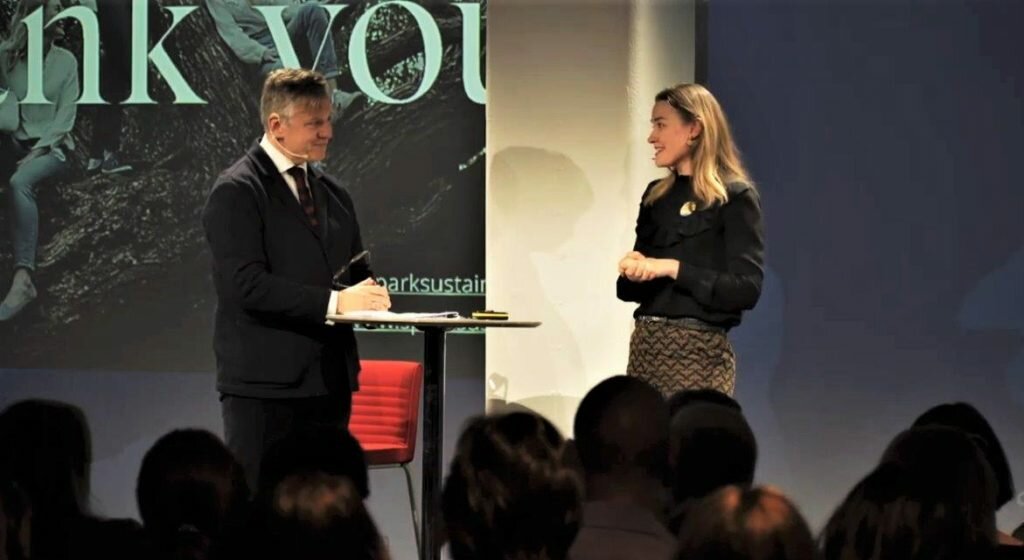 Man and woman on stage in front of an audience